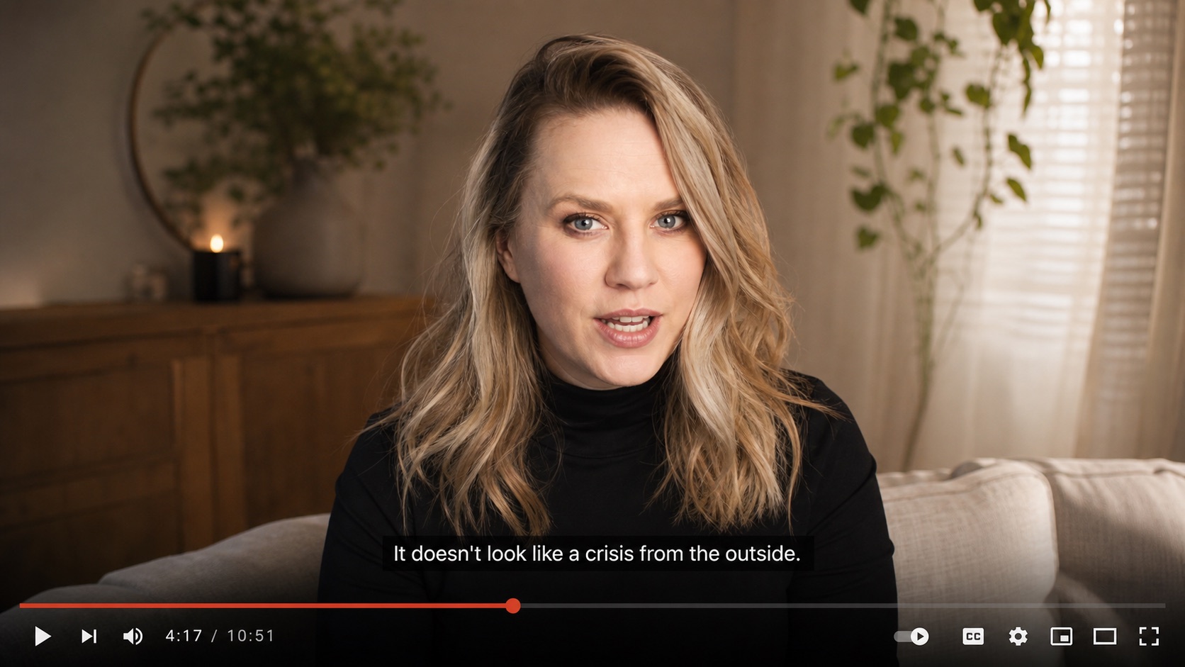 Mockup of the VSL mid-playback, showing the caption 'It doesn't look like a crisis from the outside.'